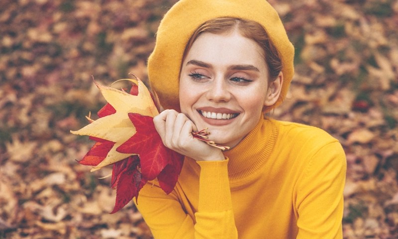 happy woman, fall leaves, fresh skin