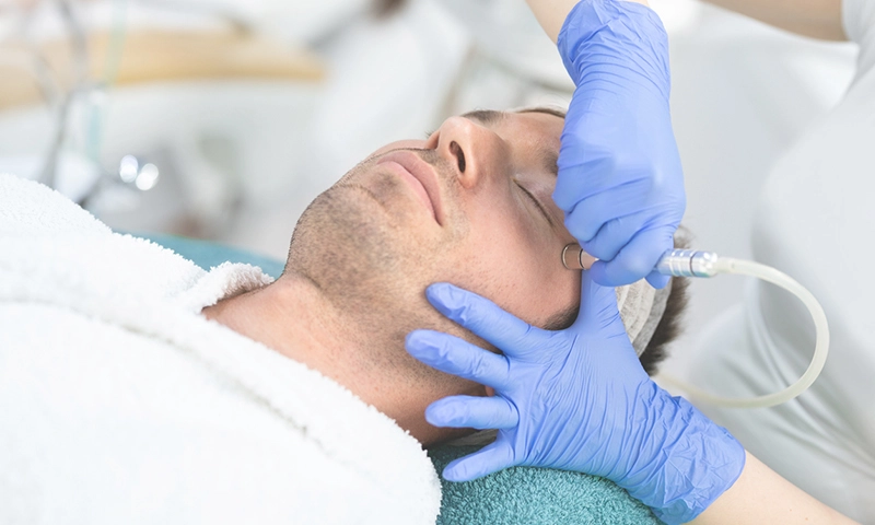 Male receiving microdermabrasion treatment