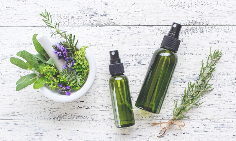 Essential oil bottles and herbs in a motor