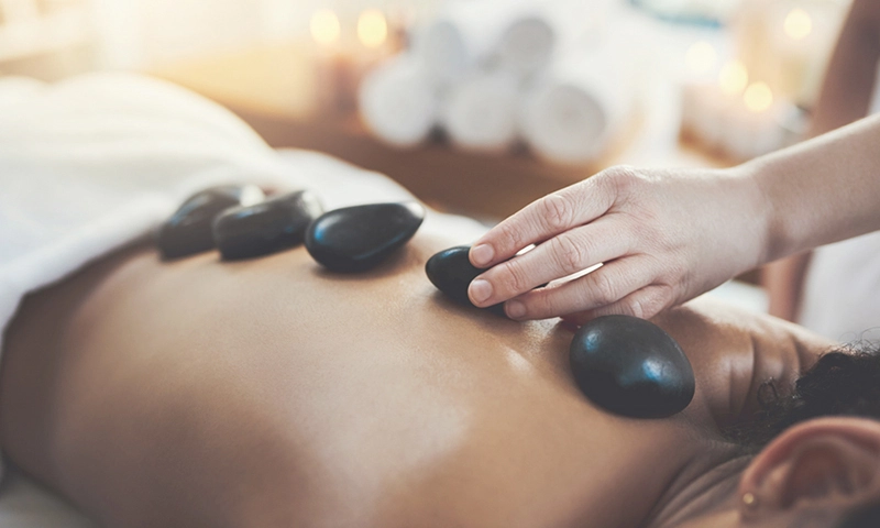 woman receiving a hot stone massage