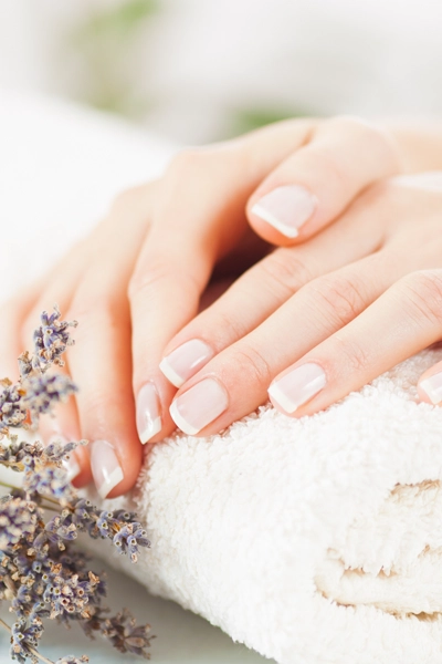 manicured hands next to lavendar