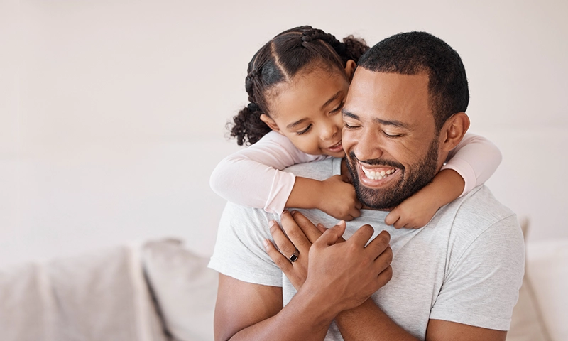 young daughter hugging father
