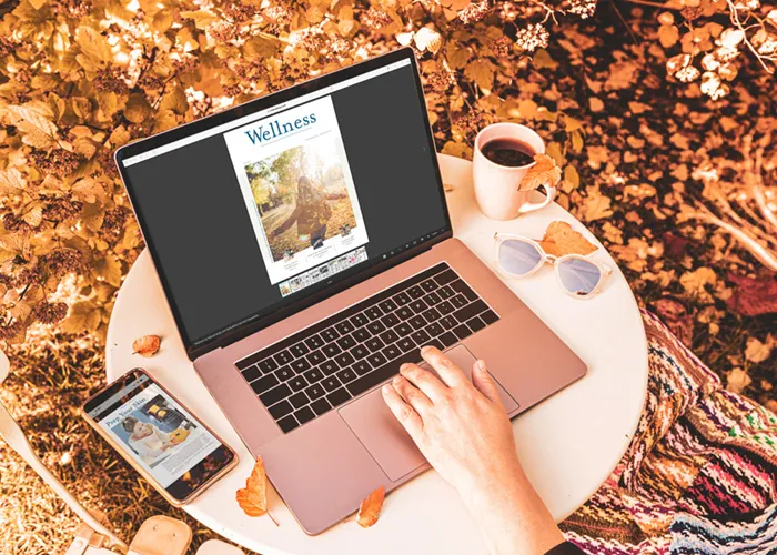 Wellness Fall newsletter on laptop and phone in Fall setting